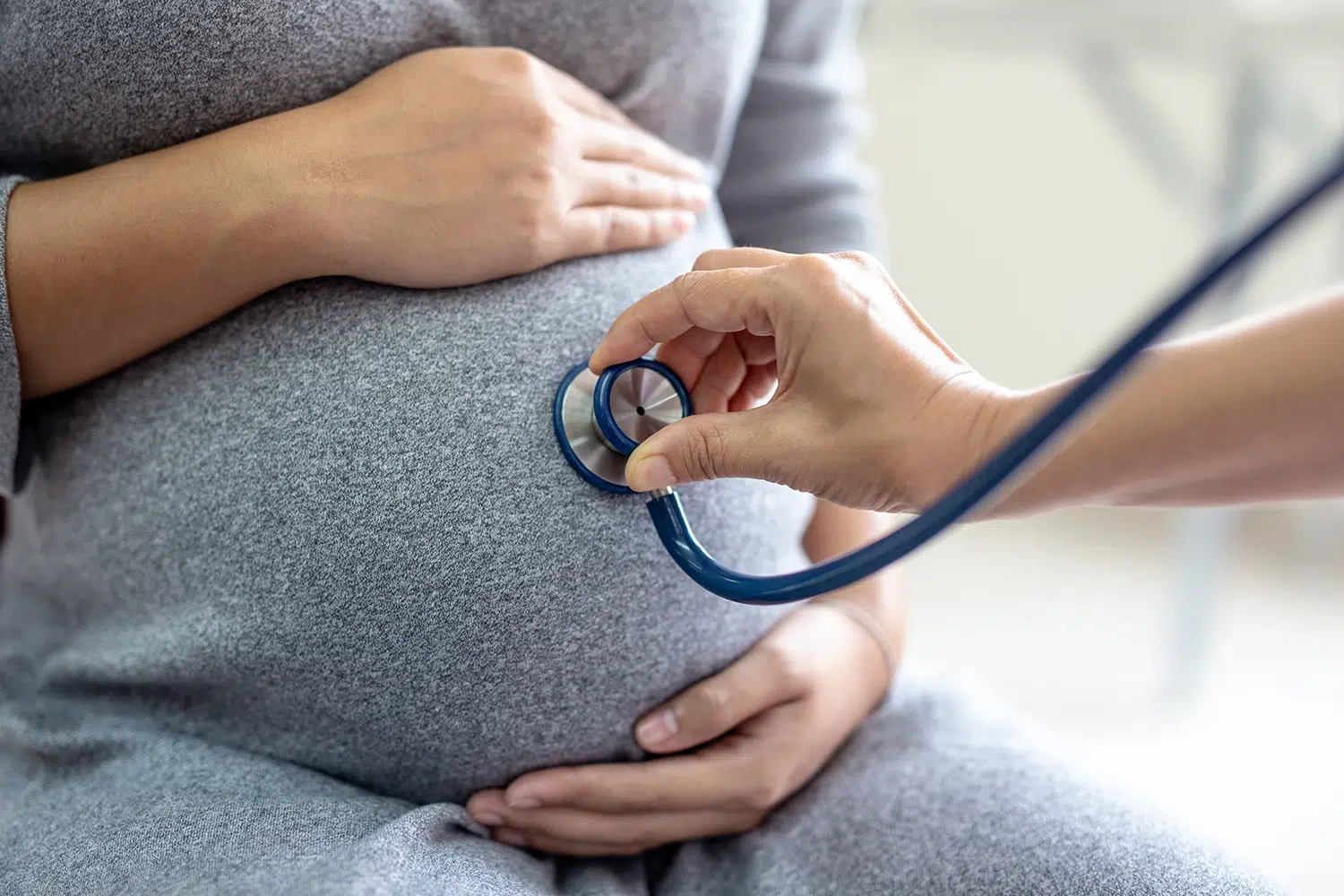 A pregnant patient being checked by a doctor at an obstetrics and gynaecology clinic